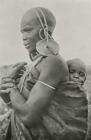 A Kikuyu Woman carrying a baby.