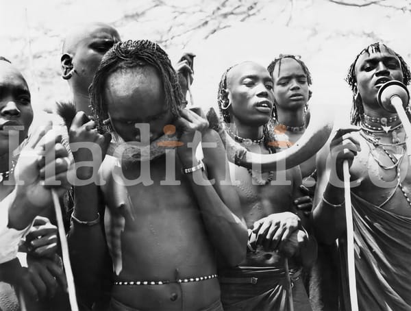 A warrior blowing a Sacred Kudu Horn.